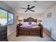 Bedroom with an elegant bed frame, side tables, and a window offering natural light at 4815 Palacio Ct, Las Vegas, NV 89122