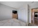 This bedroom features a large closet, dresser with television, and neutral wall color at 4815 Palacio Ct, Las Vegas, NV 89122