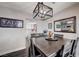 This dining room features a dark wood table, modern light fixture, and seamlessly connects to the kitchen at 4815 Palacio Ct, Las Vegas, NV 89122