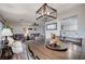 Open-concept dining area flows to the living room and kitchen, featuring wood table, seating and decor at 4815 Palacio Ct, Las Vegas, NV 89122