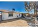 Back exterior view, showcasing a covered patio, gravel yard, and fenced perimeter for privacy at 4815 Palacio Ct, Las Vegas, NV 89122