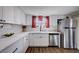 Bright kitchen with white cabinets, granite counters, stainless steel appliances, and modern fixtures at 4815 Palacio Ct, Las Vegas, NV 89122