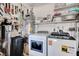 This spacious laundry room features modern washer and dryer, ample shelving, and utility sink at 4815 Palacio Ct, Las Vegas, NV 89122