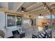 Inviting covered patio featuring a swing, cushioned seating, decorative lighting, and wood-look tile flooring at 4815 Palacio Ct, Las Vegas, NV 89122