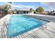 Community pool area with a sparkling blue swimming pool and shaded seating at 4815 Palacio Ct, Las Vegas, NV 89122