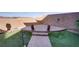 The backyard features a custom paved patio, desert landscaping, and artificial grass at 500 Via Stretto Ave, Henderson, NV 89011