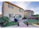 Large backyard featuring artificial grass, brick patio, and tropical foliage at 500 Via Stretto Ave, Henderson, NV 89011