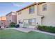 The backyard includes artificial grass, a brick-paved patio, desert landscaping, and mountain views at 500 Via Stretto Ave, Henderson, NV 89011