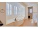 Bathroom featuring a large soaking tub, tile flooring, and modern fixtures at 500 Via Stretto Ave, Henderson, NV 89011