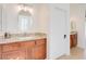 Well-lit bathroom featuring a wooden vanity with a stone countertop and tiled flooring at 500 Via Stretto Ave, Henderson, NV 89011