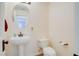 Powder room with a pedestal sink and bronze fixtures at 500 Via Stretto Ave, Henderson, NV 89011