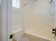 Bright bathroom featuring a shower over tub with white tile surround at 500 Via Stretto Ave, Henderson, NV 89011