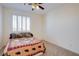 Bedroom with carpeted floor and a large window, plus a ceiling fan at 500 Via Stretto Ave, Henderson, NV 89011