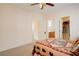 Carpeted bedroom with ceiling fan, doors to the bathroom and closet visible at 500 Via Stretto Ave, Henderson, NV 89011