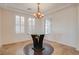 Formal dining room with tray ceiling, designer light fixture and plantation shutters at 500 Via Stretto Ave, Henderson, NV 89011