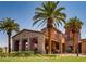 Beautiful stone clubhouse with porte-cochere entrance framed by lush landscaping and palm trees at 500 Via Stretto Ave, Henderson, NV 89011