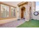 Charming front entry featuring a stone archway and wood door at 500 Via Stretto Ave, Henderson, NV 89011