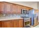 This is a kitchen featuring wood cabinets, stainless steel appliances, and a mosaic backsplash at 500 Via Stretto Ave, Henderson, NV 89011