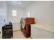 Laundry room equipped with a side-by-side washer and dryer and storage cabinets at 500 Via Stretto Ave, Henderson, NV 89011