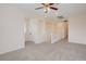 Spacious living room with plush carpeting, ceiling fan, and bright recessed lighting at 500 Via Stretto Ave, Henderson, NV 89011