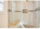 Elegant shower with marble tile, built-in bench, and stylish fixtures at 500 Via Stretto Ave, Henderson, NV 89011