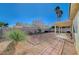 Backyard with covered patio, gravel landscaping, and brick pathway at 5205 Mantua Ct, Las Vegas, NV 89130