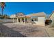 Spacious backyard with covered patio, gravel landscaping, and block wall fencing at 5205 Mantua Ct, Las Vegas, NV 89130