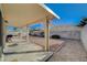 Spacious backyard with covered patio, gravel landscaping, and block wall fencing at 5205 Mantua Ct, Las Vegas, NV 89130