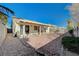 Large backyard with covered patio, gravel landscaping, and block wall fencing at 5205 Mantua Ct, Las Vegas, NV 89130