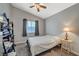 Cozy bedroom with a ceiling fan, window, and bedside table at 5205 Mantua Ct, Las Vegas, NV 89130