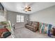 Relaxing bedroom with a comfortable couch and ceiling fan at 5205 Mantua Ct, Las Vegas, NV 89130