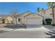 Single-story house with a two-car garage and desert landscaping at 5205 Mantua Ct, Las Vegas, NV 89130