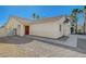 Side view of a house with a red door and gravel landscaping at 5205 Mantua Ct, Las Vegas, NV 89130