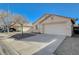 Front view of a house with a driveway and desert landscaping at 5205 Mantua Ct, Las Vegas, NV 89130