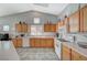 Well-equipped kitchen featuring wood cabinets and an island with seating at 5205 Mantua Ct, Las Vegas, NV 89130