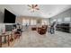 Spacious living room featuring tile floors, a fireplace, and ample natural light at 5205 Mantua Ct, Las Vegas, NV 89130