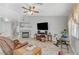 Living room with a fireplace, and view into the kitchen and access to the backyard at 5205 Mantua Ct, Las Vegas, NV 89130