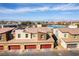 A neighborhood aerial view showing modern townhome design with community park, with mountains in the distance at 546 Foothill Cove Ln, Henderson, NV 89002