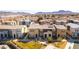 A bird's-eye view of a neighborhood highlighting modern home design and community green spaces at 546 Foothill Cove Ln, Henderson, NV 89002