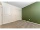 Bedroom with double closet doors and neutral-colored carpet at 546 Foothill Cove Ln, Henderson, NV 89002