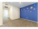 Bedroom with sunny blue accent wall, carpeted floors, and bright natural light at 546 Foothill Cove Ln, Henderson, NV 89002