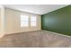 Spacious bedroom with plush carpet, an accent wall, and bright windows offering lots of light at 546 Foothill Cove Ln, Henderson, NV 89002