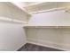 Walk-in closet with custom shelving and neutral carpet at 546 Foothill Cove Ln, Henderson, NV 89002