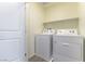 Convenient laundry room equipped with a washing machine, dryer, and built-in shelf at 546 Foothill Cove Ln, Henderson, NV 89002