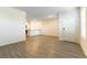 Open-concept living space with hard surface flooring leading to a bright kitchen with white cabinets at 546 Foothill Cove Ln, Henderson, NV 89002