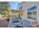 Backyard featuring a covered patio, clear blue sky, and desert landscaping at 6086 Shadow Oak Dr, North Las Vegas, NV 89031