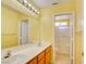 Bathroom features a double sink vanity with a large mirror and a shower with glass doors at 6086 Shadow Oak Dr, North Las Vegas, NV 89031