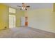 Bright bedroom with a ceiling fan, large window, and access to an ensuite bathroom at 6086 Shadow Oak Dr, North Las Vegas, NV 89031