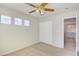 Simple bedroom with a ceiling fan, three windows, neutral paint and a closet at 6086 Shadow Oak Dr, North Las Vegas, NV 89031