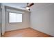 Simple bedroom with neutral walls, ceiling fan, and wood floors at 6086 Shadow Oak Dr, North Las Vegas, NV 89031